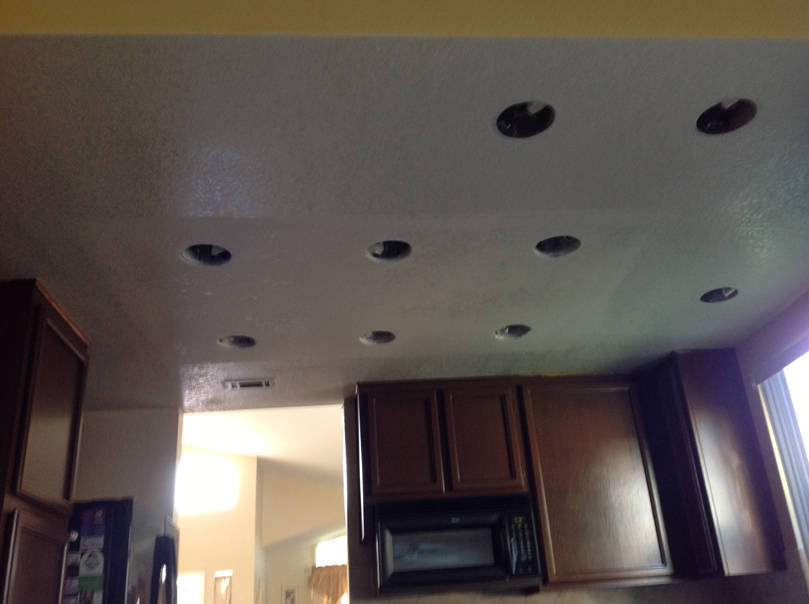 Kitchen ceiling after drywall repair around recessed lights