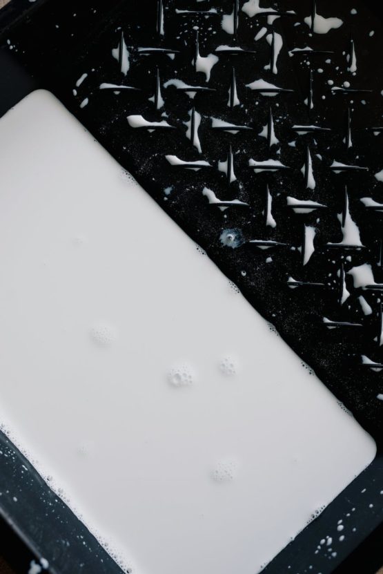 white oil paint in plastic tank