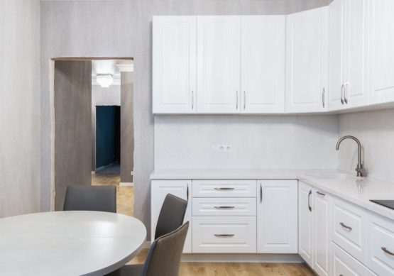 modern kitchen interior with cabinets against table at home