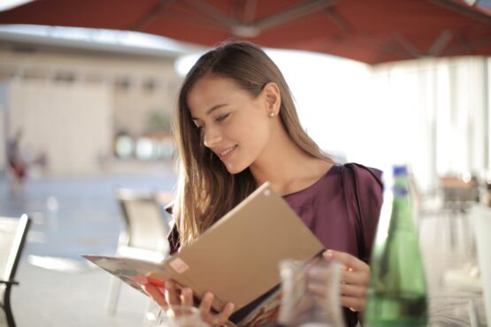 woman in purple top reading menu