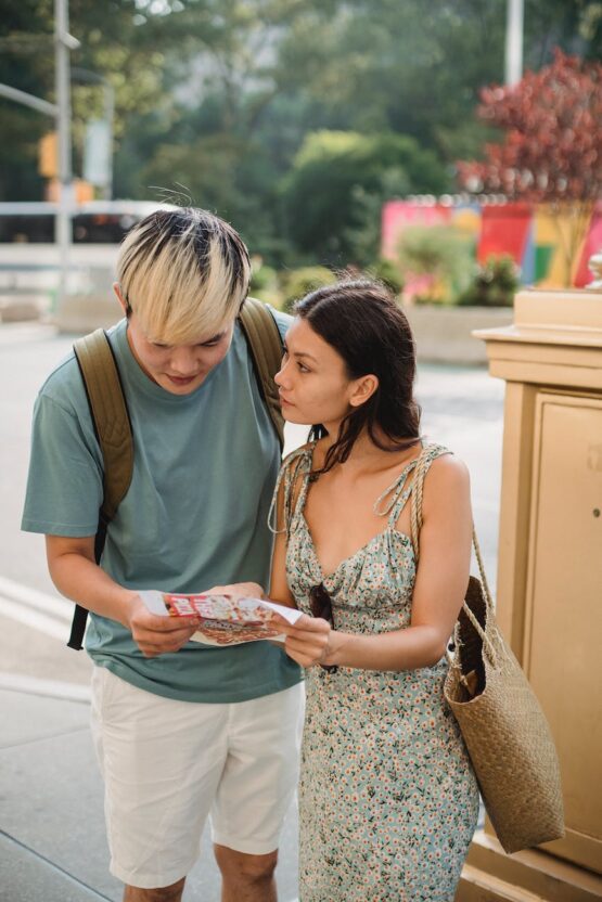 couple searching route in map while traveling together