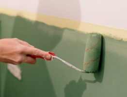 person painting wall in apartment