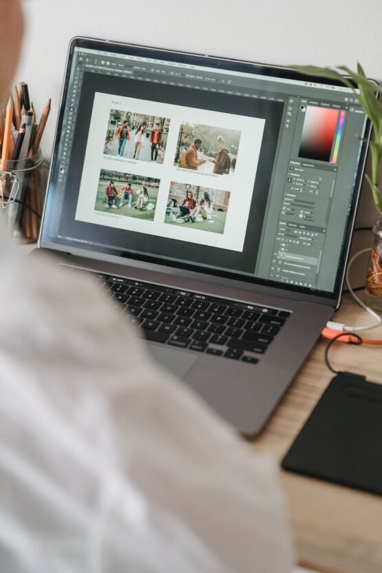 unrecognizable person working on laptop and choosing photos