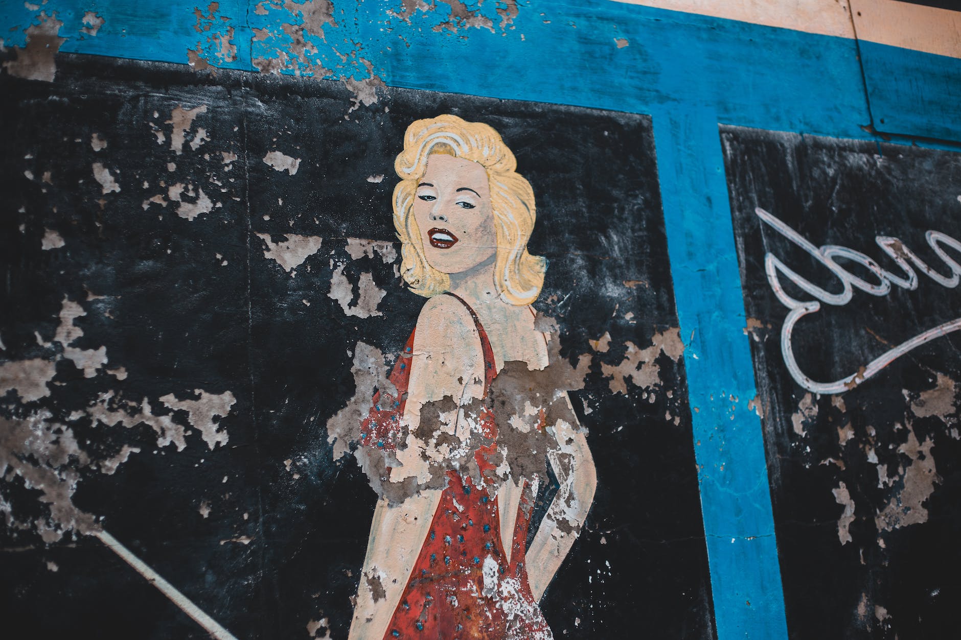 painting of woman on shabby wall