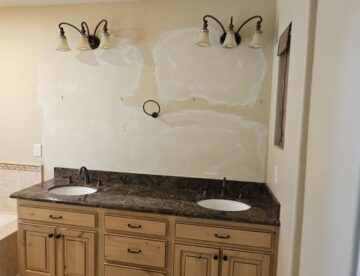 Smooth texture drywall repair above bathroom sink after