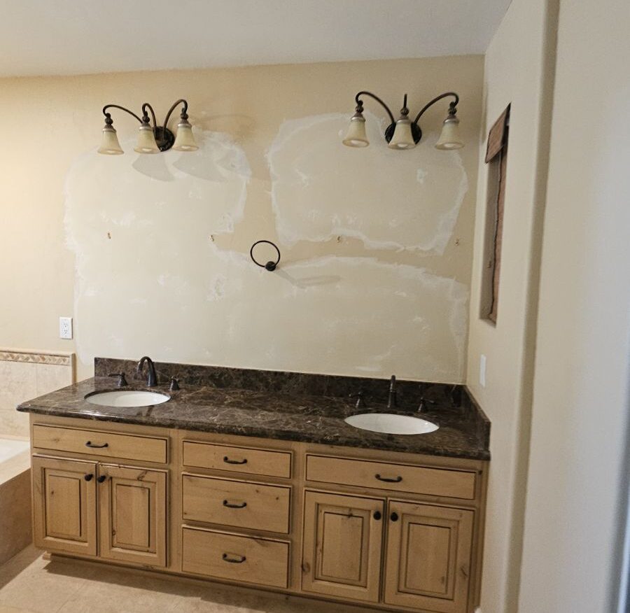 Smooth texture drywall repair above bathroom sink after