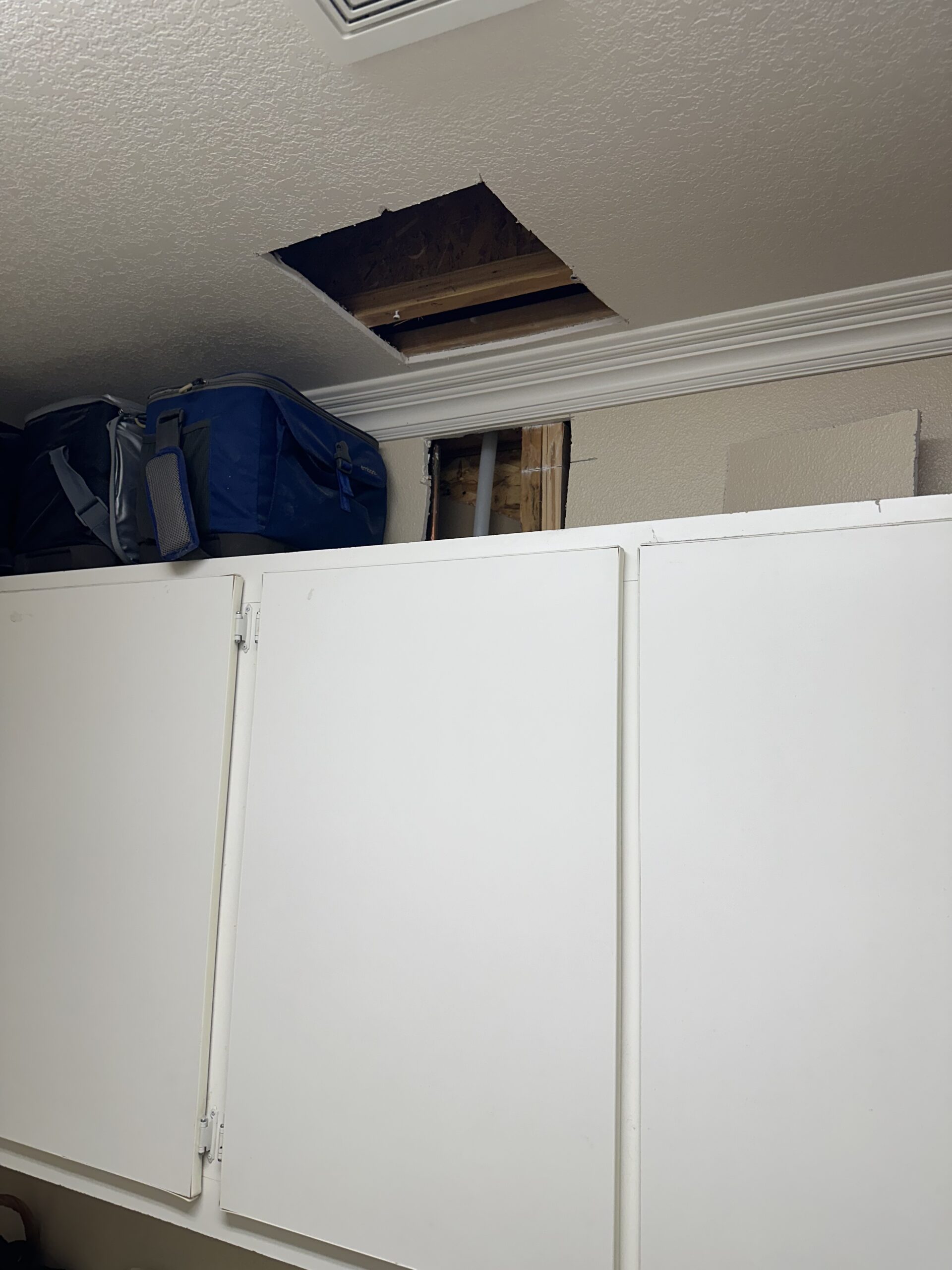 Drywall repairs in laundry room before