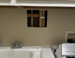 Drywall repair in laundry room wall before